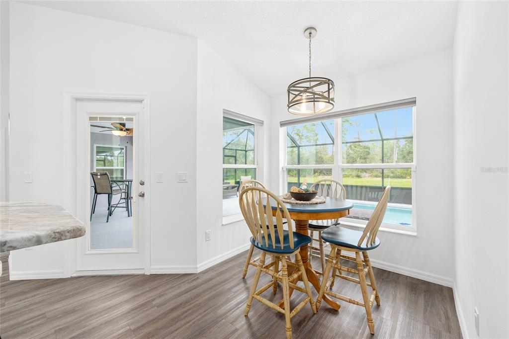 8381 North Wayside Avenue Dunnellon, FL 34433 - Photo 24 of 37 a view of a dining room with furniture wooden floor and a chandelier