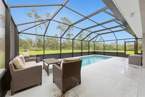 a view of a patio with couches and umbrella