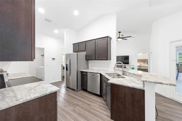 a kitchen with a sink stove and refrigerator