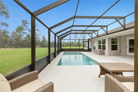 a view of swimming pool with a patio