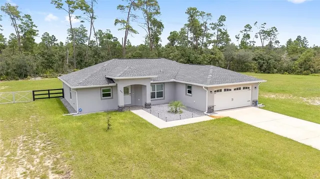 a aerial view of a house with yard patio and backyard