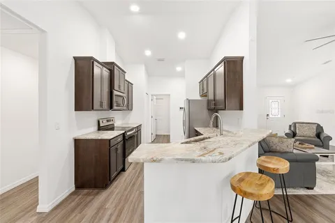 a kitchen with granite countertop counter space a sink appliances and cabinets
