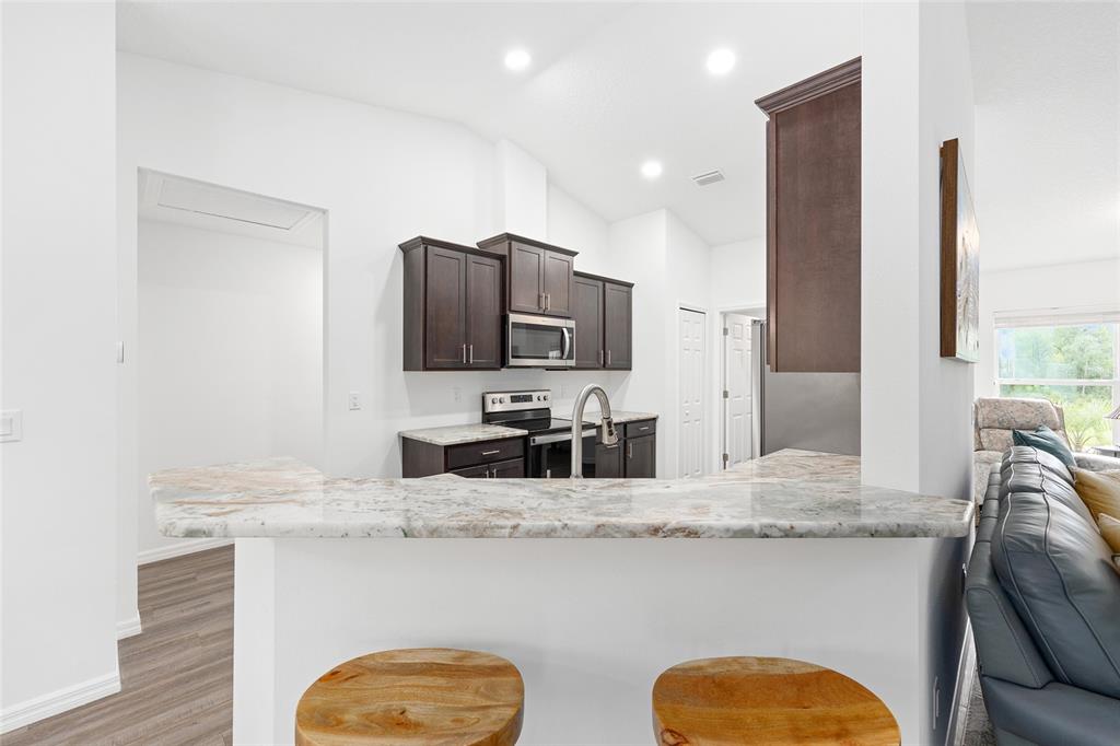 8381 North Wayside Avenue Dunnellon, FL 34433 - Photo 5 of 37 a kitchen with stainless steel appliances granite countertop a sink a stove and a refrigerator