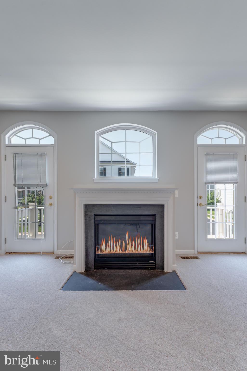 42429 Redstone Terrace Brambleton, VA 20148 - Photo 14 of 35 a living room with furniture and a fireplace
