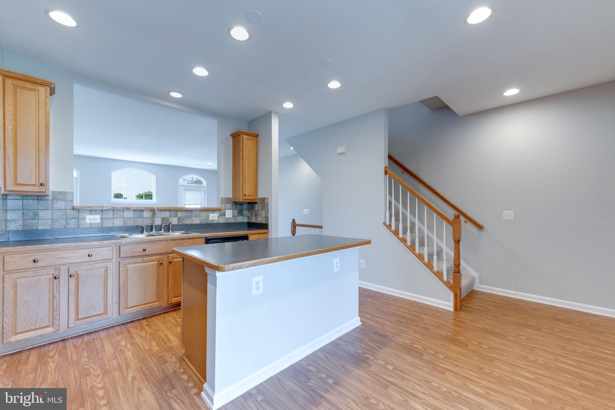 42429 Redstone Terrace Brambleton, VA 20148 - Photo 17 of 35 a kitchen with stainless steel appliances granite countertop a sink and cabinets