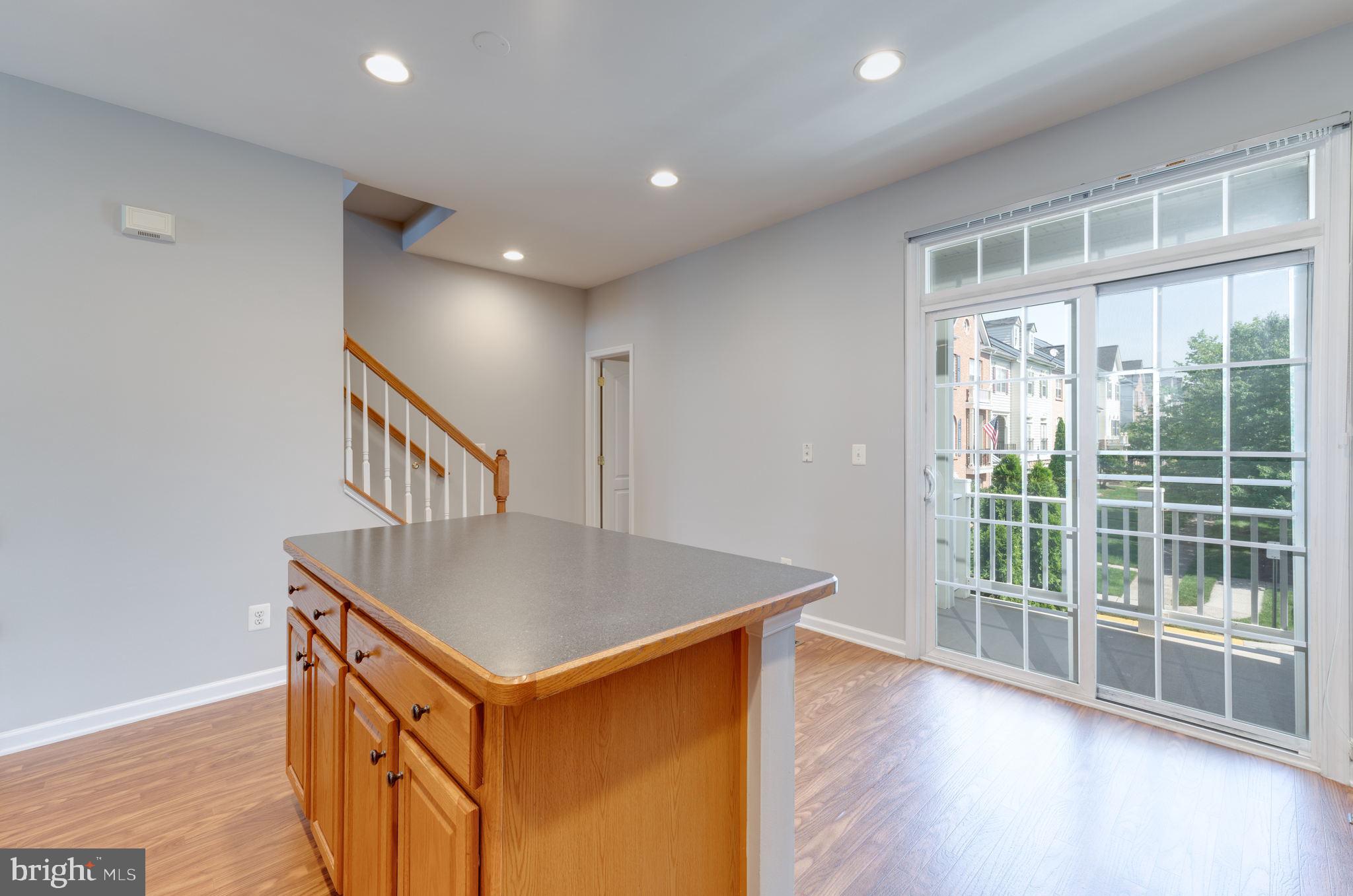 42429 Redstone Terrace Brambleton, VA 20148 - Photo 18 of 35 a room with wooden floor and windows