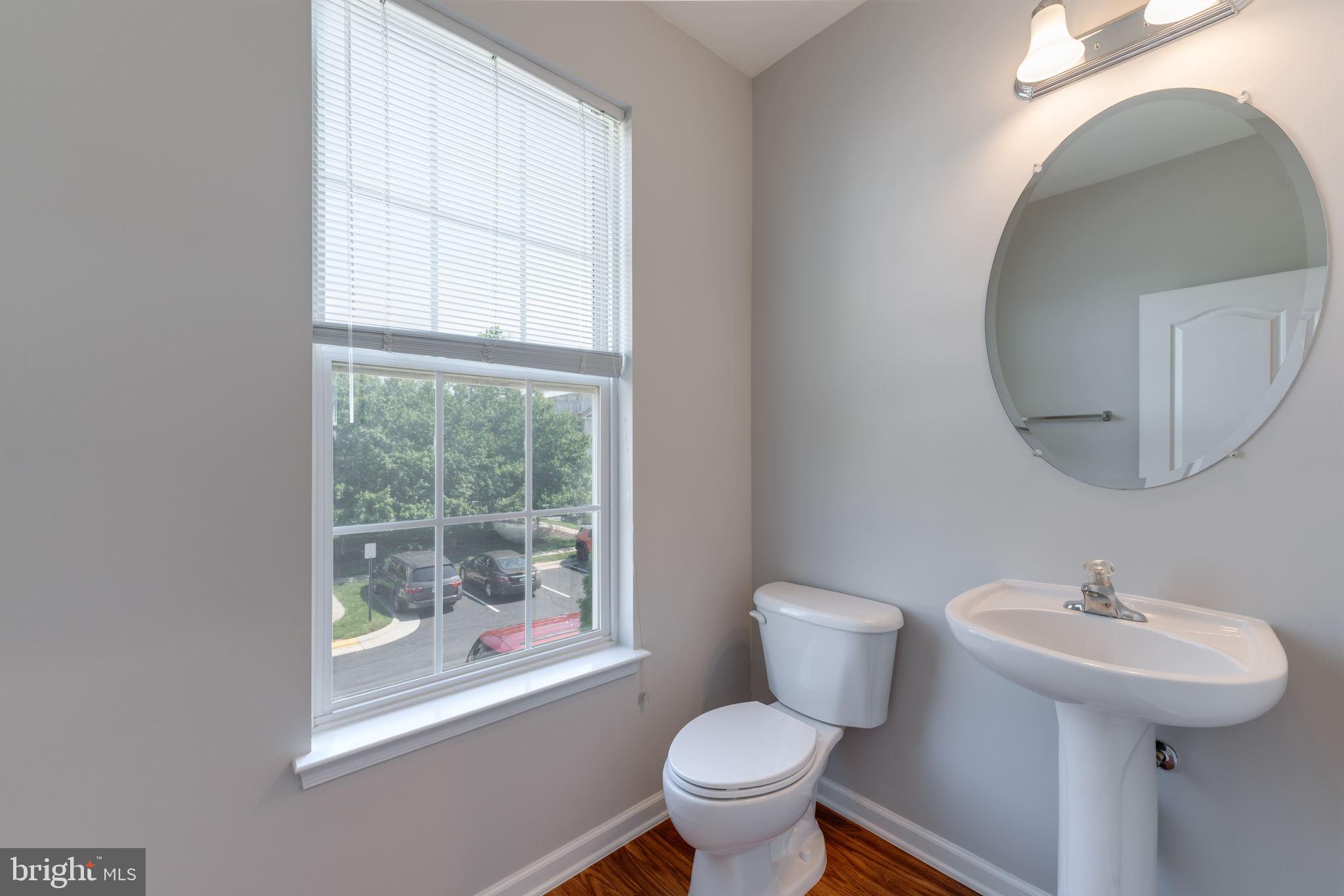 42429 Redstone Terrace Brambleton, VA 20148 - Photo 20 of 35 a bathroom with a toilet sink and mirror
