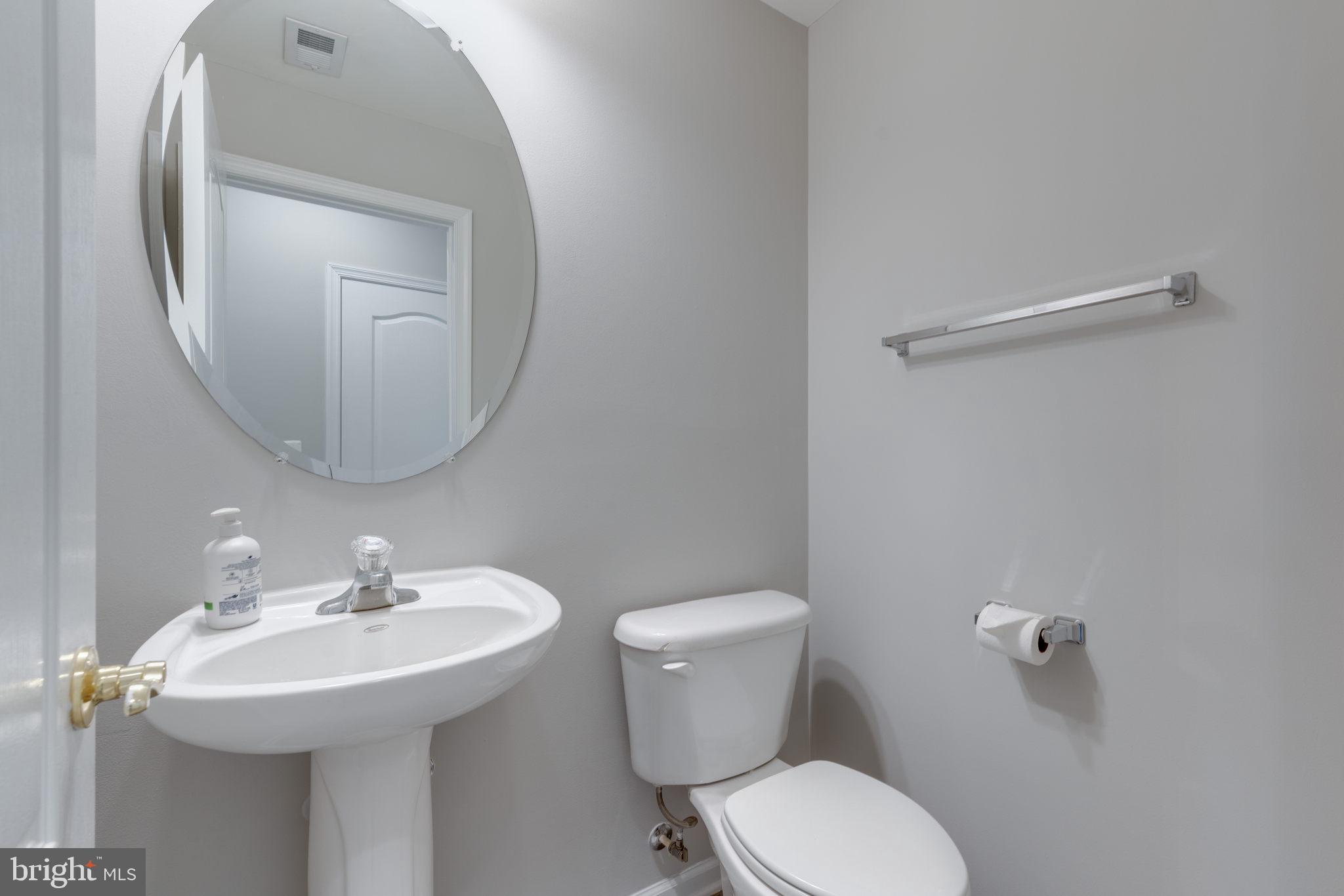 42429 Redstone Terrace Brambleton, VA 20148 - Photo 8 of 35 a bathroom with a toilet sink and mirror