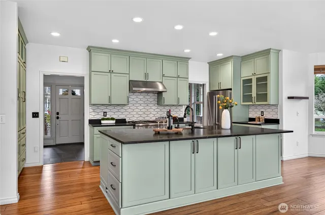 a kitchen with stainless steel appliances granite countertop a sink and cabinets