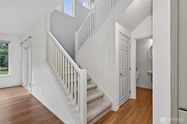 a view of a hallway with wooden floor and entryway