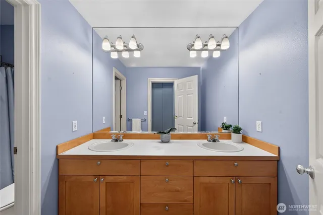 a bathroom with a sink vanity and a mirror