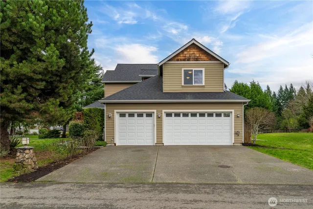 a view of front of house with a yard and garage