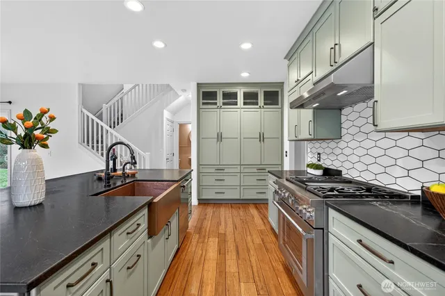 a kitchen with granite countertop a stove and a sink