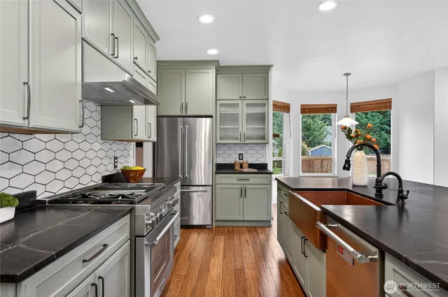 a kitchen with a sink appliances and cabinets