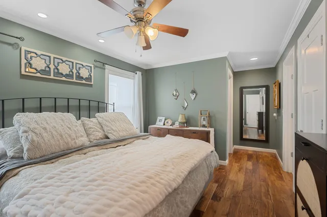 a bedroom with a large bed and a chandelier