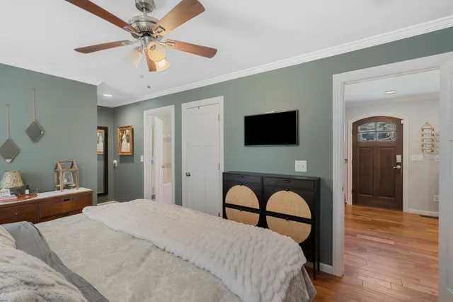 a bedroom with a bed and wooden floor