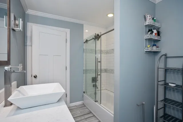 a bathroom with a tub shower and window