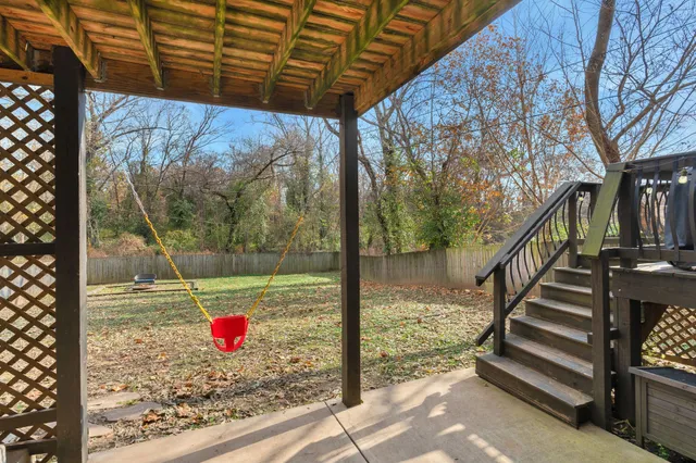 a view of a wooden door with a tree in front of it
