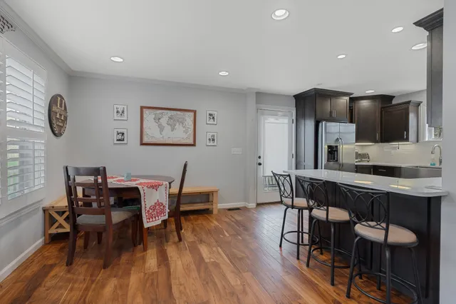 a view of a dining room with furniture and wooden floor