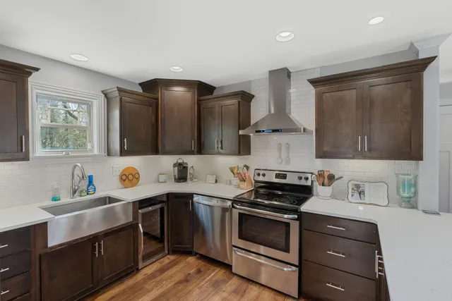 a kitchen with stainless steel appliances a sink stove and cabinets