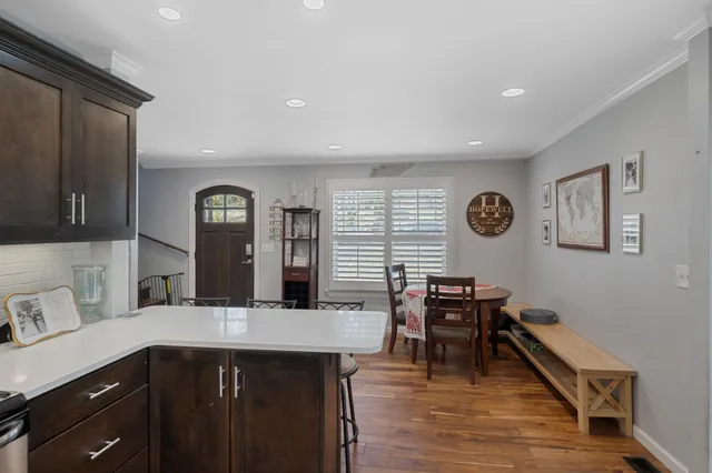a kitchen with stainless steel appliances granite countertop a sink and dishwasher with wooden floor