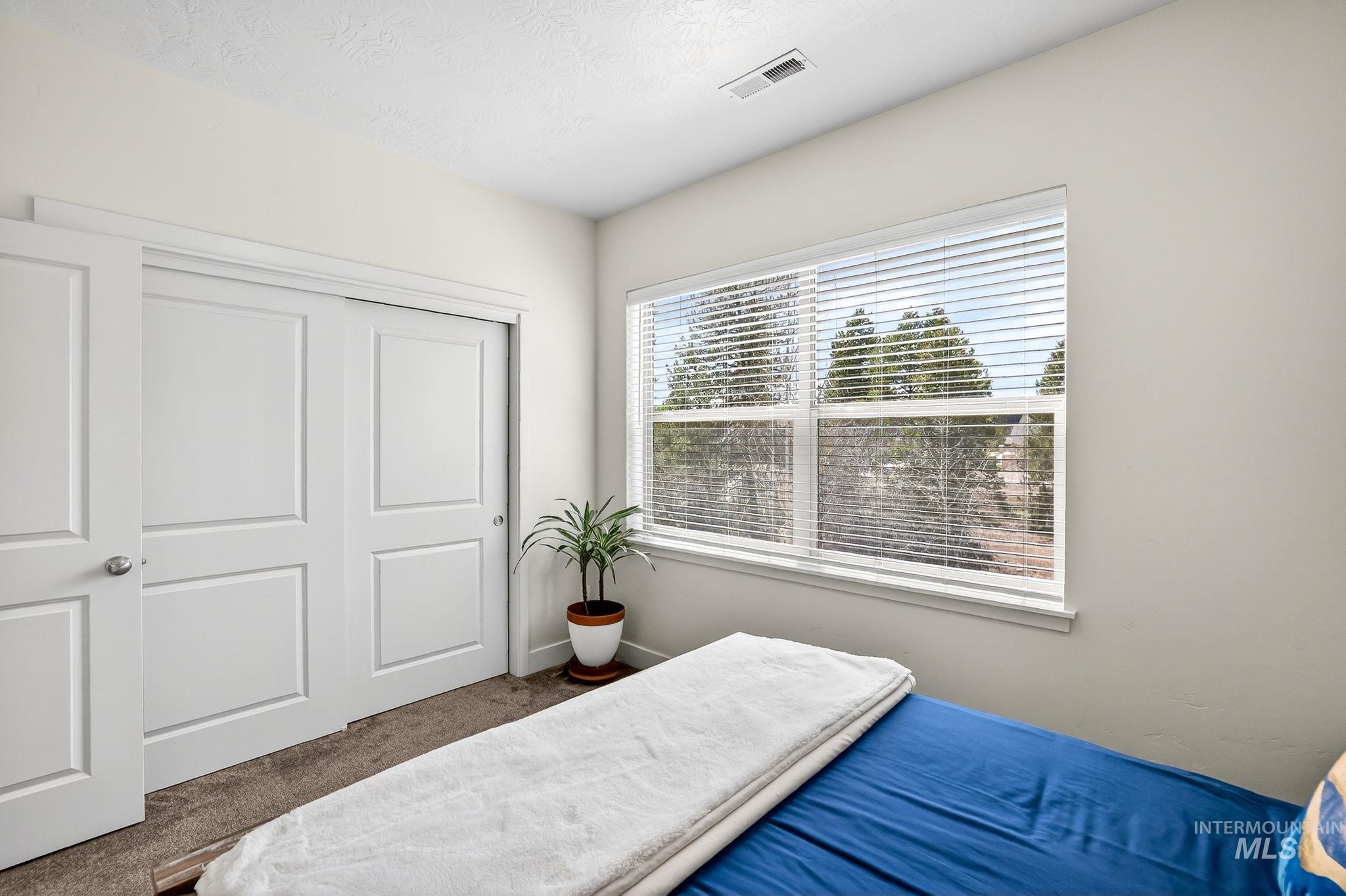 311 Broken Ridge Way McCall, ID 83638 - Photo 20 of 44 Bright interior space featuring a large window with horizontal blinds, providing natural light