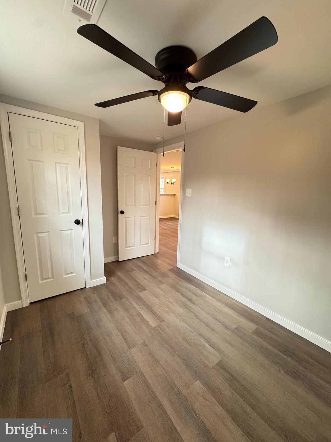 7178 Jericho Road Ruther Glen, VA 22546 - Photo 11 of 18 an empty room with wooden floor and windows