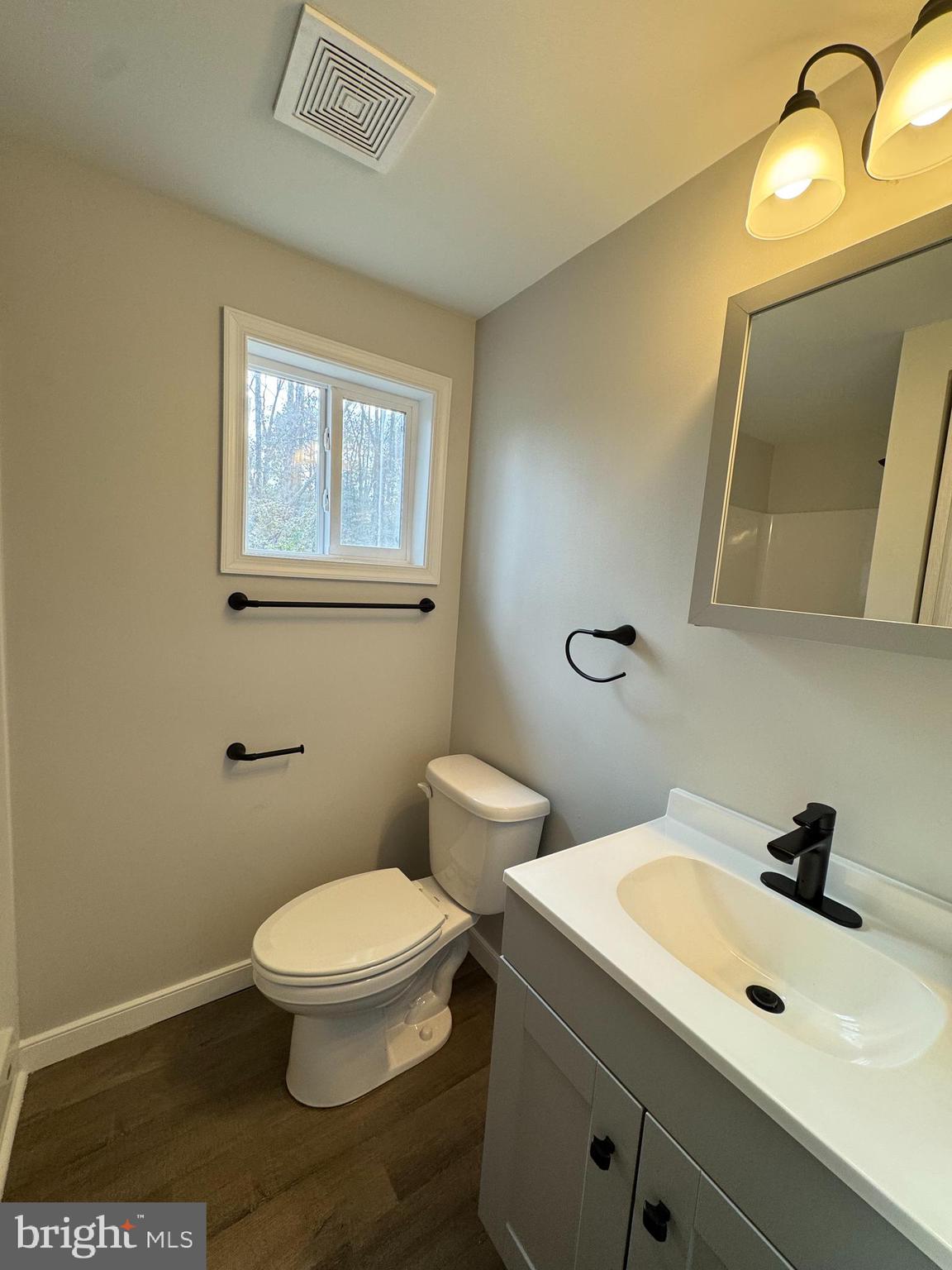 7178 Jericho Road Ruther Glen, VA 22546 - Photo 14 of 18 a bathroom with a toilet sink and mirror