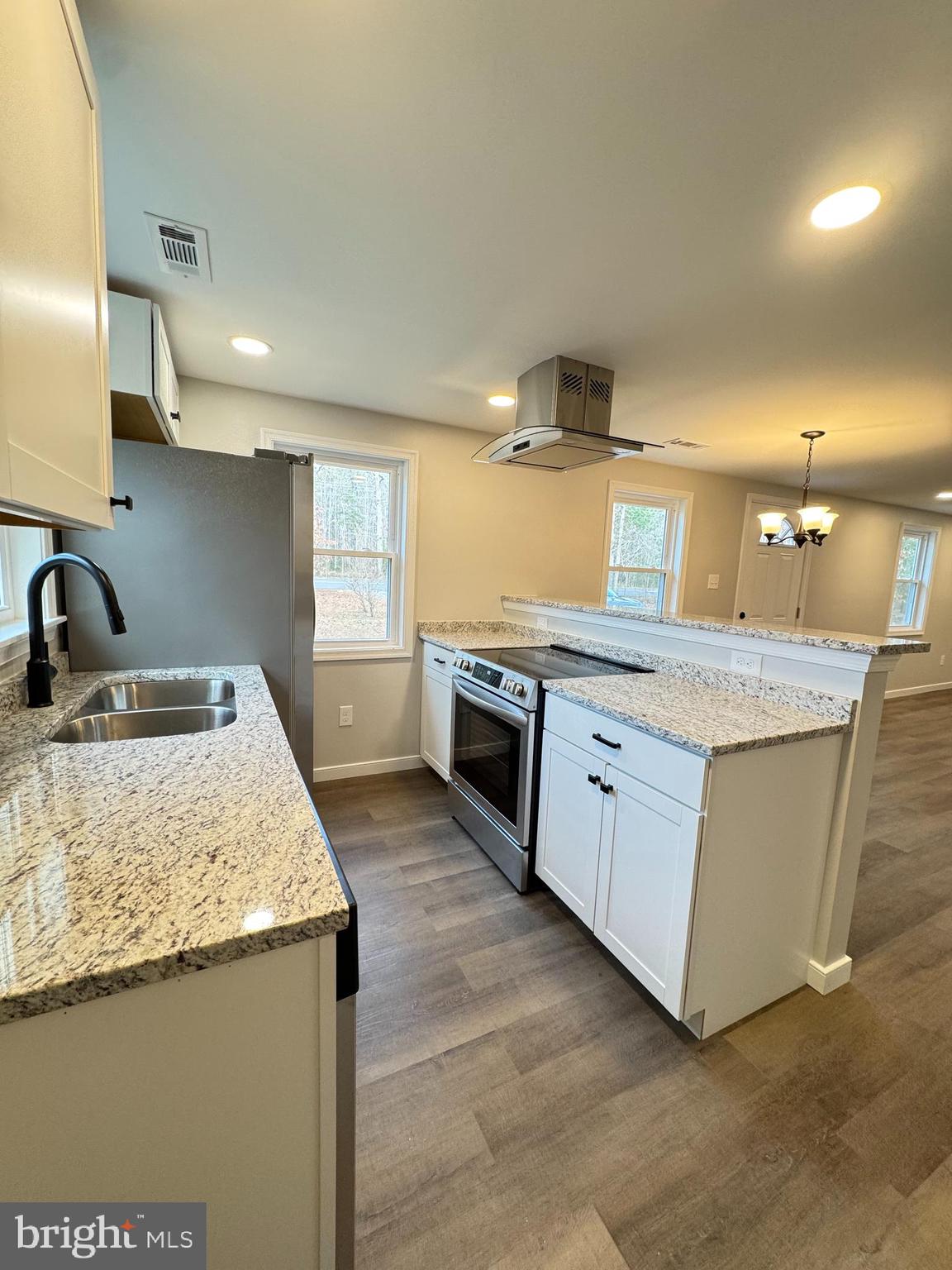 7178 Jericho Road Ruther Glen, VA 22546 - Photo 2 of 18 a kitchen with stainless steel appliances granite countertop a sink and a stove