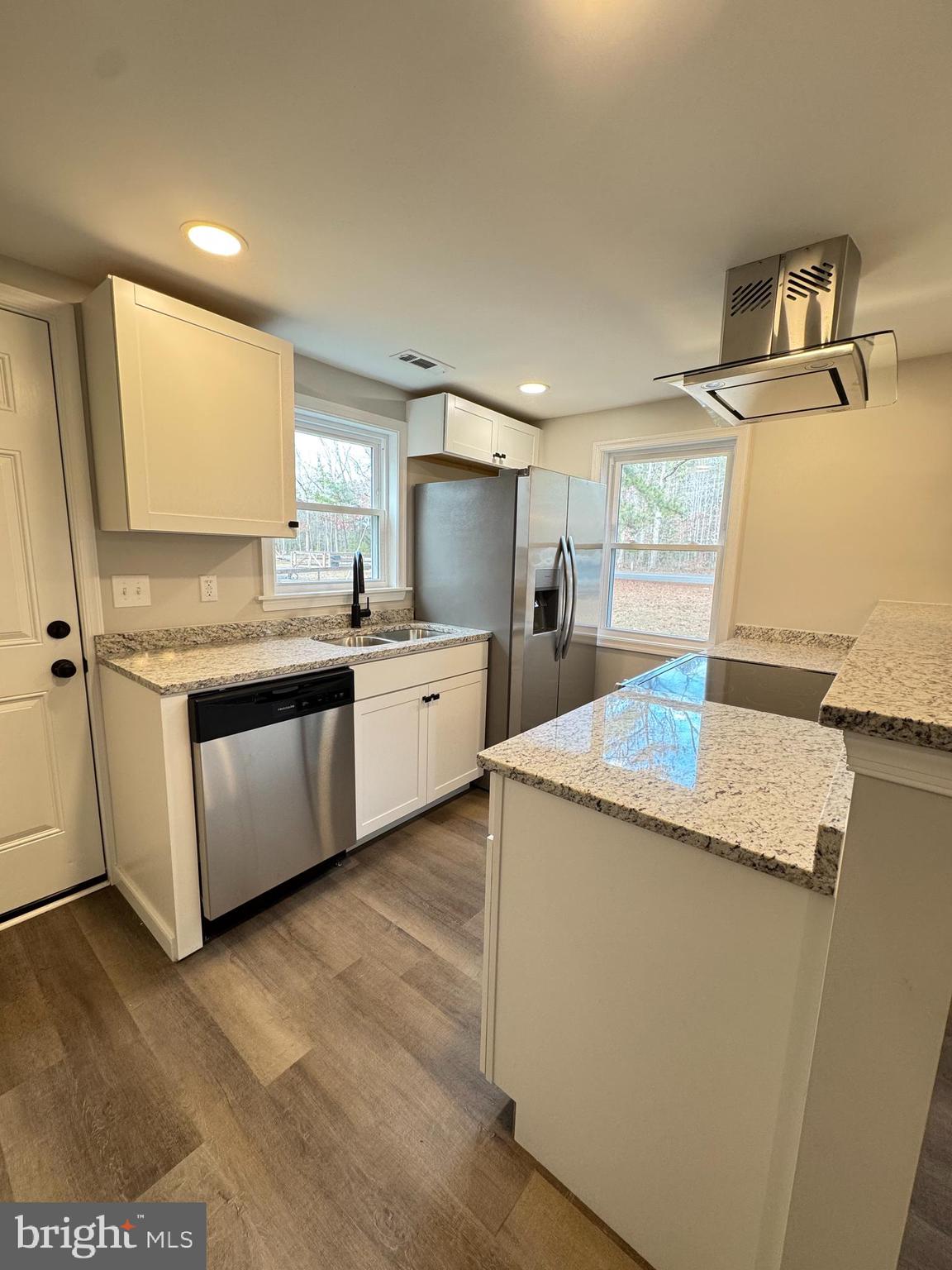 7178 Jericho Road Ruther Glen, VA 22546 - Photo 3 of 18 a kitchen with kitchen island a sink a stove and a refrigerator