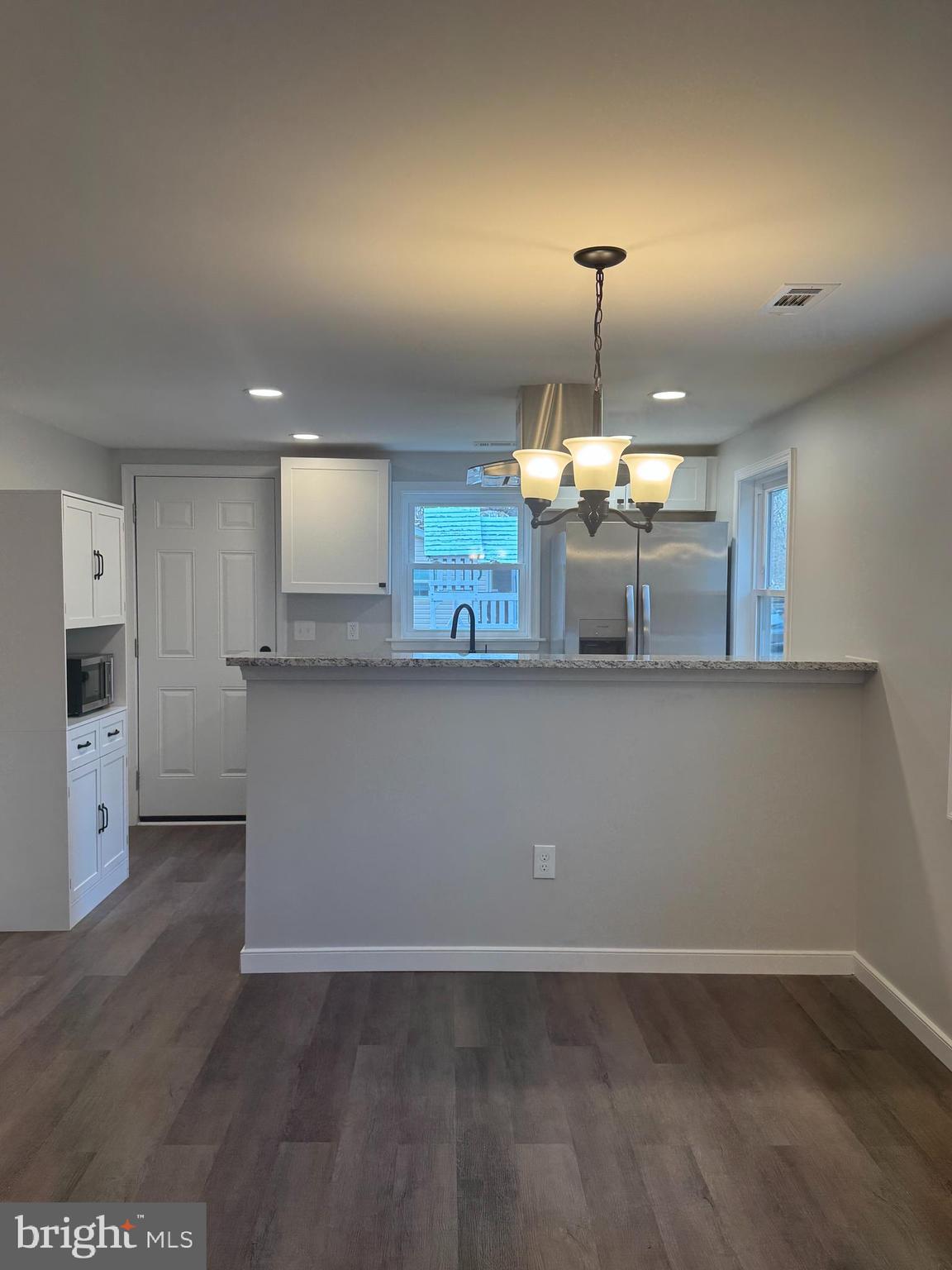 7178 Jericho Road Ruther Glen, VA 22546 - Photo 5 of 18 a kitchen with kitchen island a counter top space a sink stainless steel appliances and cabinets