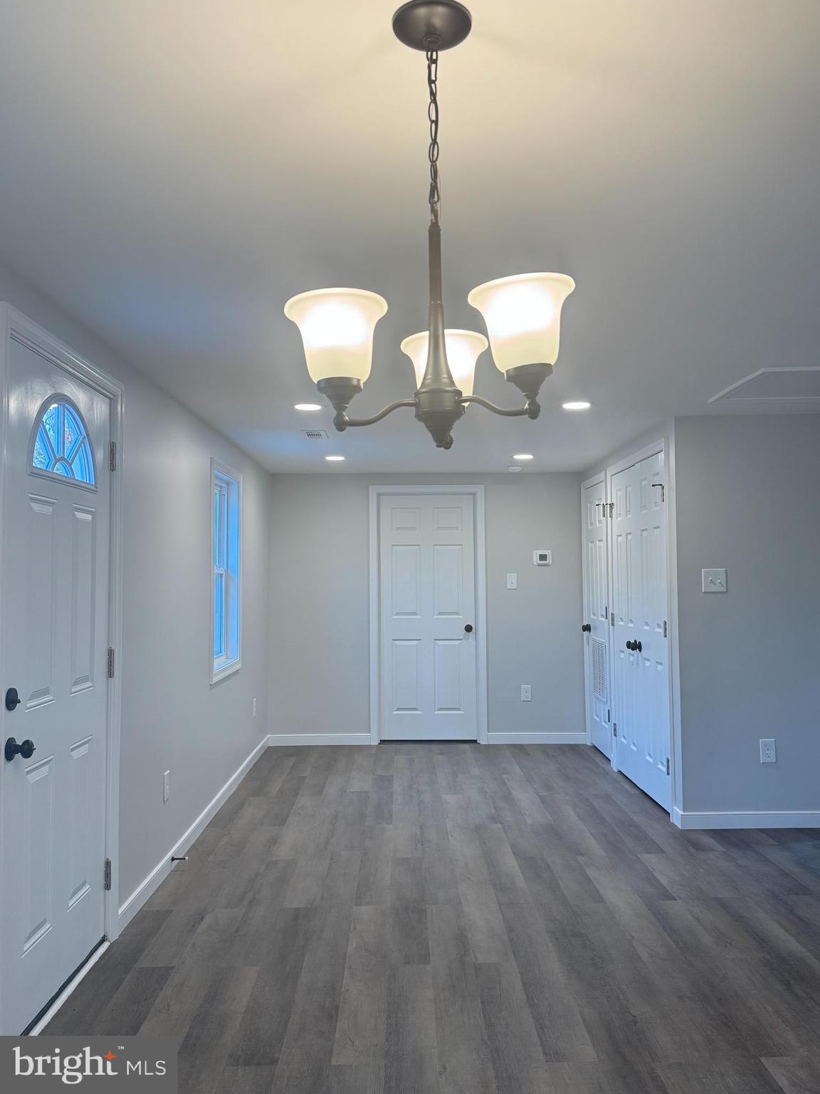 7178 Jericho Road Ruther Glen, VA 22546 - Photo 6 of 18 a view of a room with wooden floor and chandelier