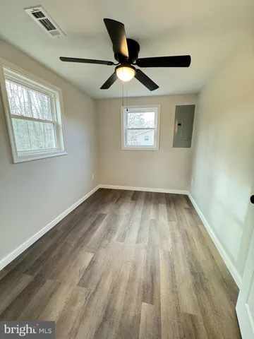 wooden floor in an empty room with a window