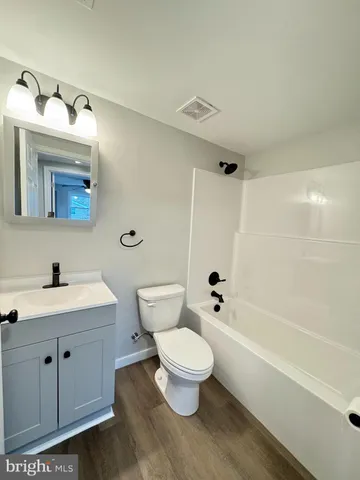 a bathroom with a toilet a sink and bathtub