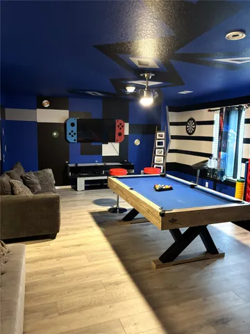a living room with furniture pool and flat screen tv