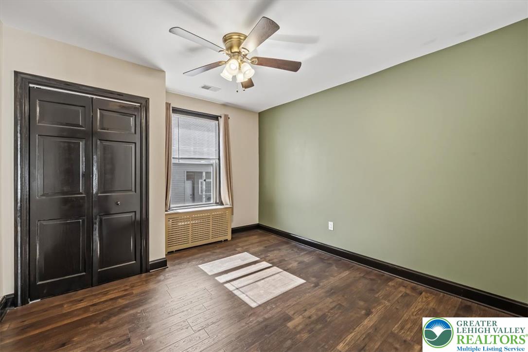 3453 Main Street Slatington, PA 18080 - Photo 13 of 30 Hardwood floors and a ceiling fan create a comfortable atmosphere in this well-appointed bedroom.