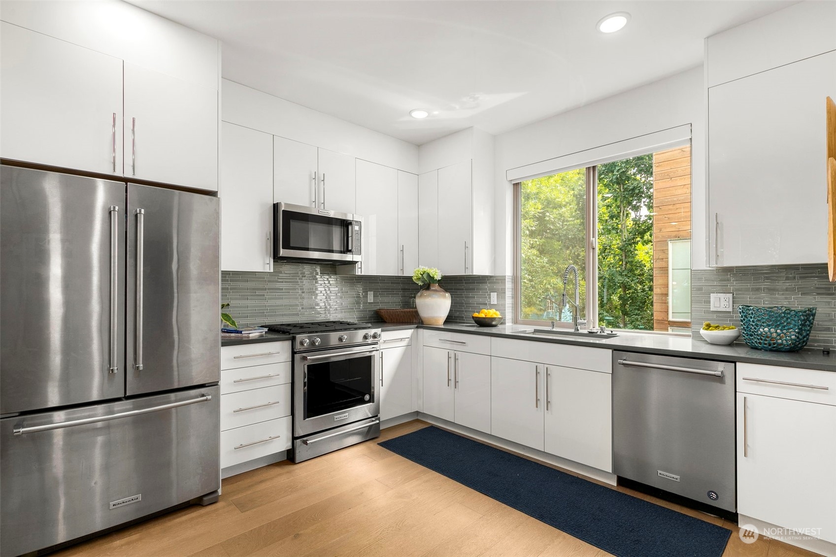 200 20th Avenue South Seattle, WA 98144 - Photo 5 of 22 a kitchen with stainless steel appliances a refrigerator sink and microwave