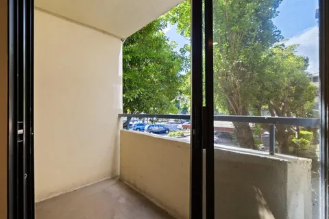 a view of a glass door with a balcony from a room