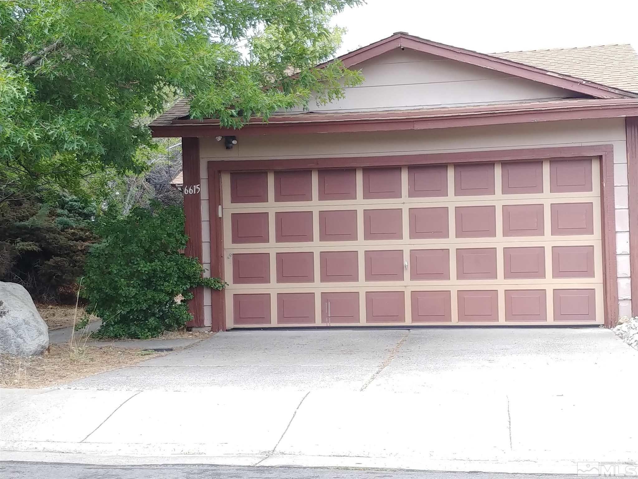 6615 Lotus Street Reno, NV 89506 - Photo 1 of 16 a front view of a house with a parking space