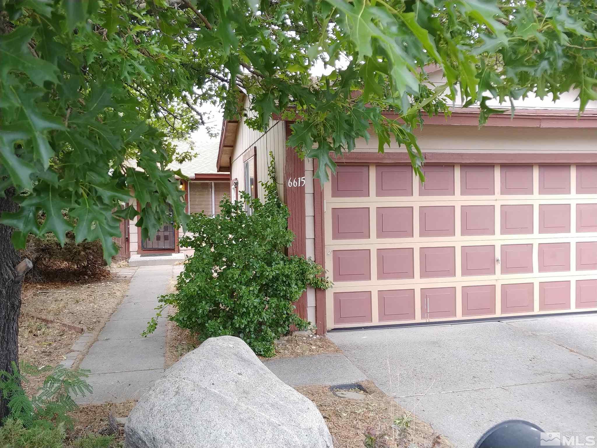 6615 Lotus Street Reno, NV 89506 - Photo 2 of 16 a view of a house with a yard and potted plants