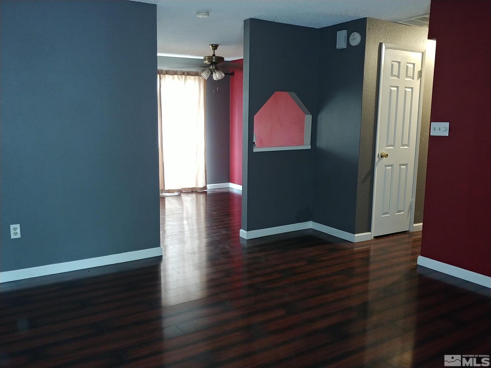 6615 Lotus Street Reno, NV 89506 - Photo 4 of 16 an empty room with wooden floor closet and windows