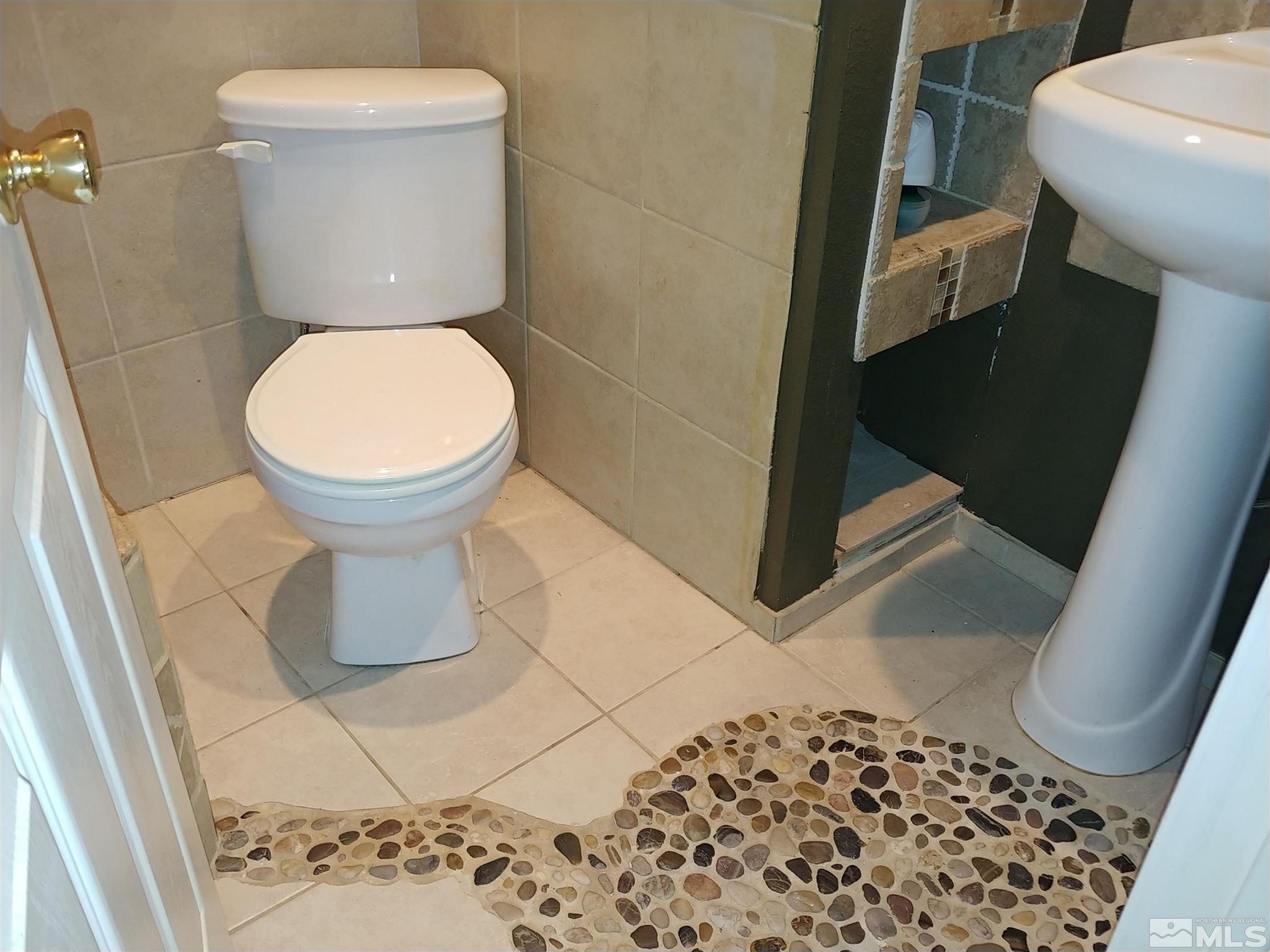 6615 Lotus Street Reno, NV 89506 - Photo 9 of 16 a bathroom with a toilet and a sink