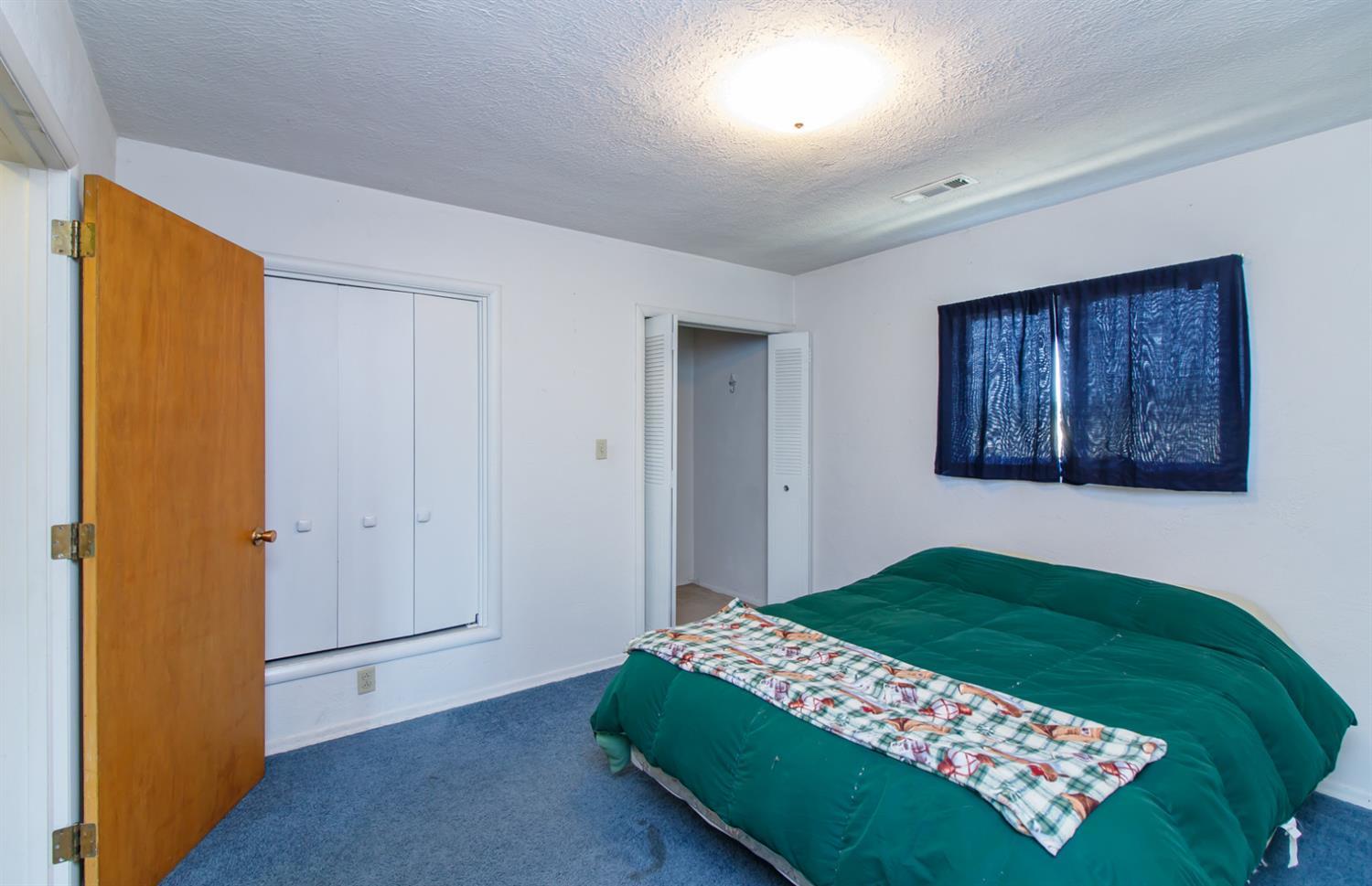 1039 West Valley View Road Ashland, OR 97520 - Photo 18 of 32 a bedroom with a bed and a painting on the wall