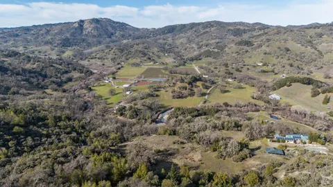 a view of a mountain in the distance in a field