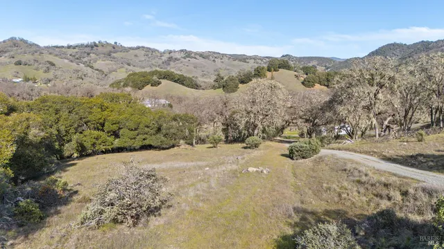 a view of a road with mountains in the background
