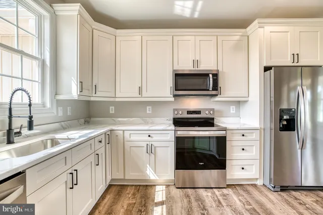 an empty room with windows and closet