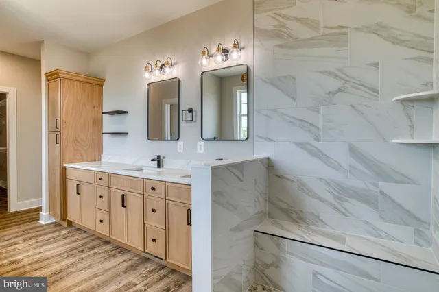 a white bed sitting in a bedroom next to a white wall