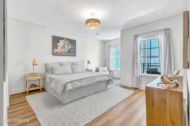 a spacious bedroom with a bed a couch and a window