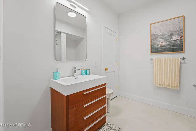 a bathroom with a sink a mirror and a vanity