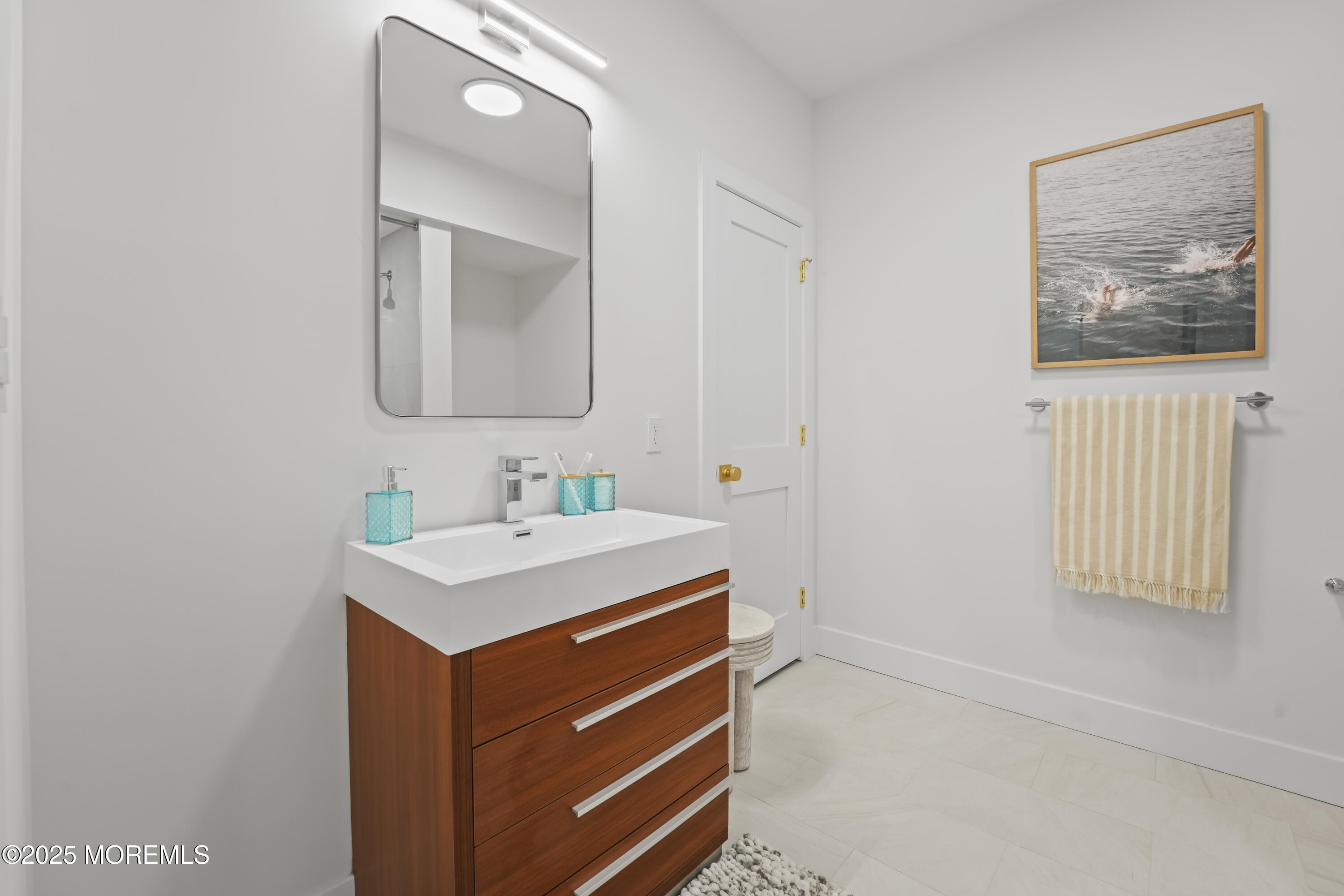 33 Hamilton Avenue, Unit 2 Seaside Heights, NJ 08751 - Photo 19 of 32 a bathroom with a sink a mirror and a vanity